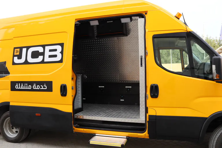 Side loading door open, showing the chequer-plate lined floor and interior of the workshop body