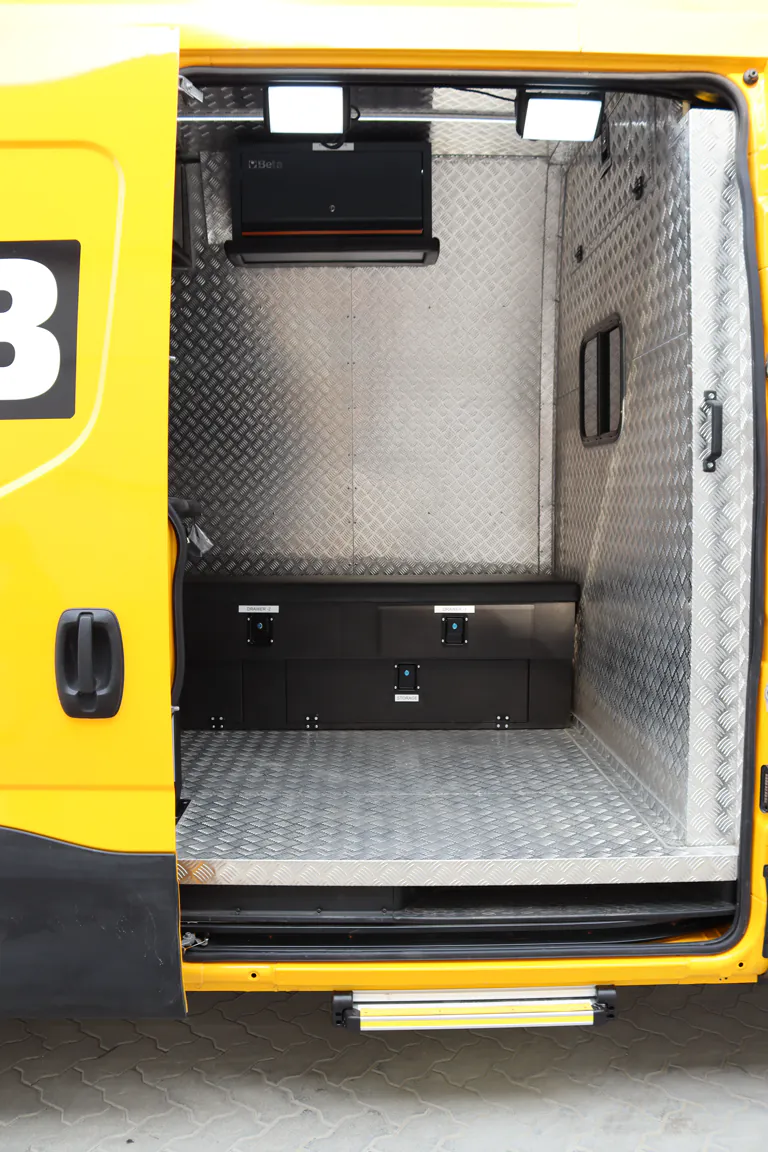 Vertical view through the open side door into the lined and fitted workshop cabin