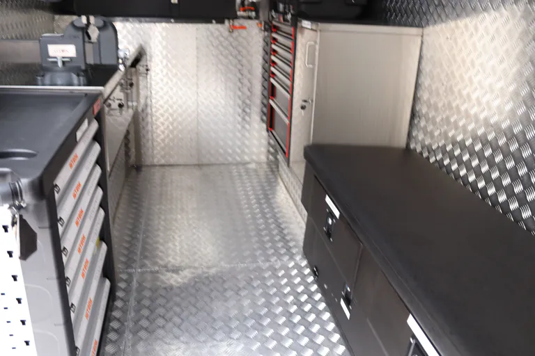 Length of the cabin showing the workbench, drawer units and shadow board along one side